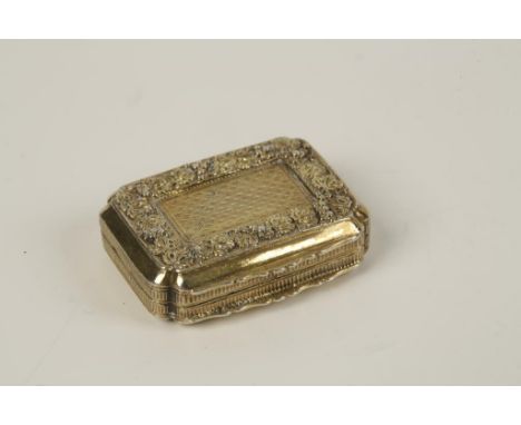 A GEORGE III SILVER GILT VINAIGRETTE of shaped rectangular form with re-entrant corners, raised foliate border and engine-tur