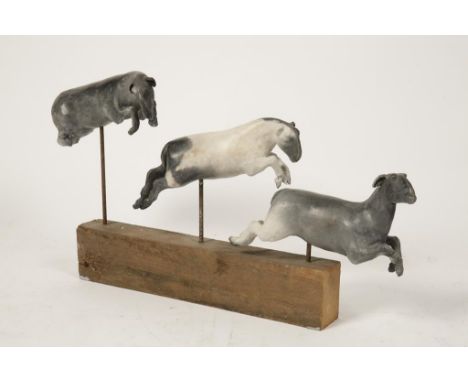 TANYA BRETT (b.1974), 'Leaping Sheep', three ceramic sheep in various jumping poses on a wooden base and metal rods, c.19" x 