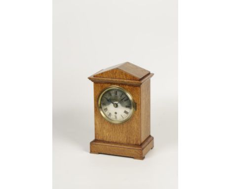 AN EARLY 20TH CENTURY OAK CASED MANTLE CLOCK, the circular silver dial inscribed RAF beneath the crown and flanked by outstre