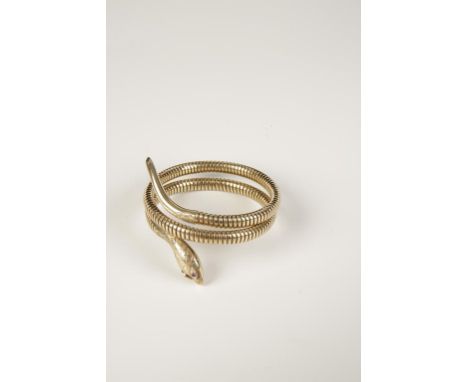 A 9CT YELLOW GOLD SERPENT BANGLE, sprung, the engraved head with ruby cabochon eyes, hallmarked. 