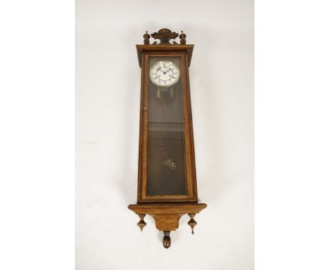 A VIENNA WALL CLOCK, with two train movement, in a glazed golden oak case, 46" high