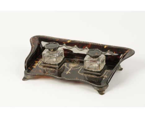 AN EDWARDIAN SILVER MOUNTED TORTOISESHELL INKSTAND of shaped rectangular form with inlaid silver and pique-work decoration, t