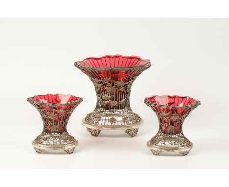 A GARNITURE OF THREE EDWARDIAN PIERCED VASES, each of waisted oval form, with rope-work borders, the wire-work bodies applied