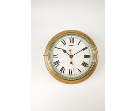 AN EARLY 20TH CENTURY BRASS DRUM WALL CLOCK, 12" wide.