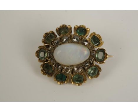 AN OPAL, EMERALD AND DIAMOND BROOCH, the central oval opal cabochon surrounded by a rose-cut diamond border and an individual