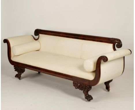A WILLIAM IV MAHOGANY SOFA, with scrolled back with foliate and leaf carved ends above a cream upholstered seat and scrolling