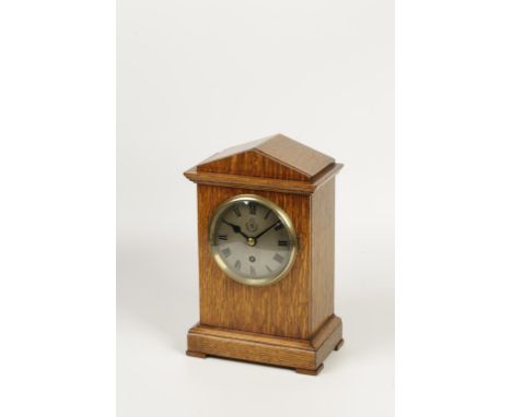 AN EARLY 20TH CENTURY OAK CASED BRACKET CLOCK, the silvered dial marked RAF beneath a crown and within a laurel wreath, with 