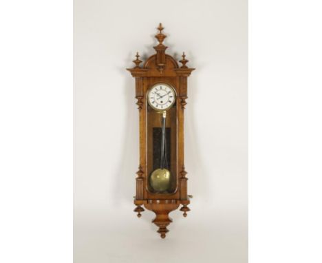 A VIENNA WALL CLOCK, with single train movement, in an architechtural walnut case, 37" high