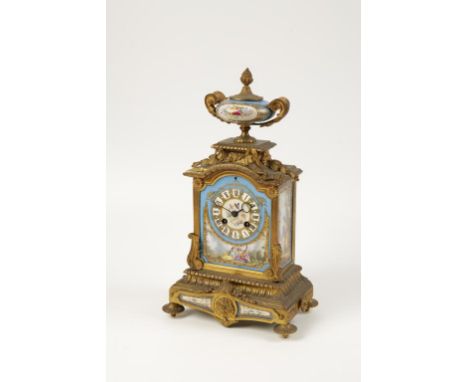 A FRENCH GILT METAL AND 'SEVRE' STYLE PORCELAIN MOUNTED MANTLE CLOCK, the painted dial with Roman numerals above a scene of a