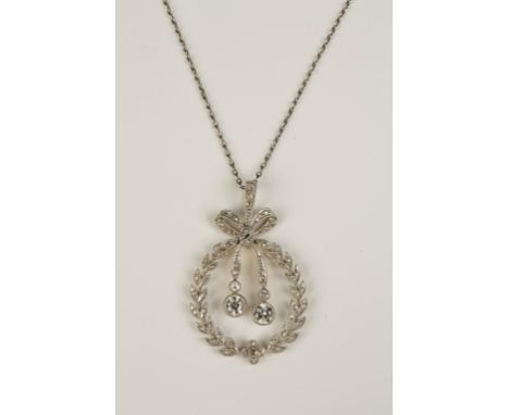 AN EDWARDIAN DIAMOND PENDANT, of wreath and ribbon tie form, milligrain-set overall with round, old-cut diamond accents, susp