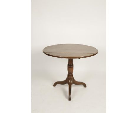 A GEORGE III MAHOGANY PILLAR TABLE, the circular tip-top on a turned column and three outswept legs, 35.5" wide