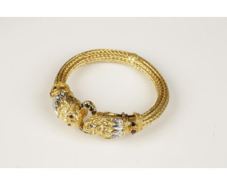 ILIAS LALOUNIS: AN 18CT YELLOW GOLD MESH BANGLE, the chimera terminals set with diamonds, sapphires and rubies, joined by a s