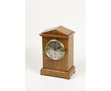 AN EARLY 20TH CENTURY OAK CASED MANTLE CLOCK, the circular silver dial inscribed RIF beneath the crown and flanked by outstre