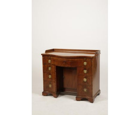 A LATE GEORGE III MAHOGANY SERPENTINE FRONTED DESK, the shaped top with three-quarter raised gallery above a brushing slide a