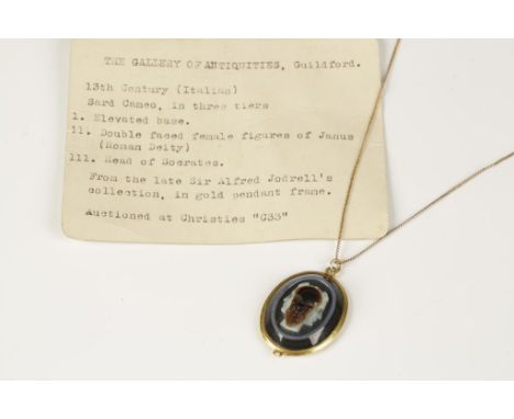 AN ITALIAN SARD CAMEO, carved with the double-headed figure of Janus and the head of Socrates, in an unmarked gold pendant fr