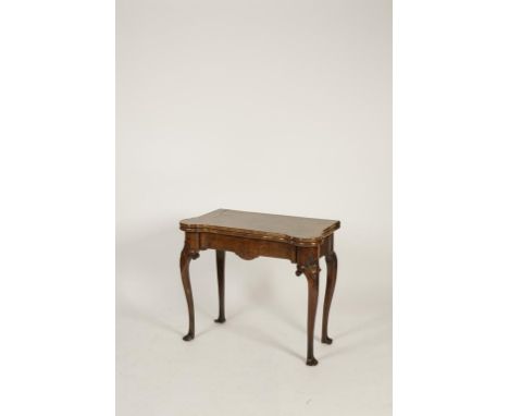 A GEORGE II WALNUT CARD TABLE opening on a concertina action, the well-figured top with projecting corners opening to reveal 