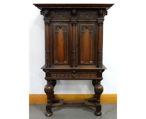 A Dutch architectural oak and ebony cabinet on stand, late 17th c, the carved frieze of shells and leafy scrolling foliage wi