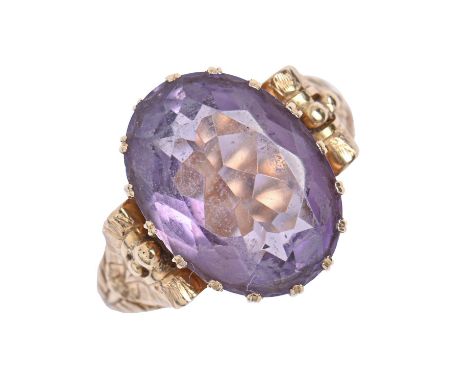 A Continental amethyst ring, in gold, with chased hoop and leaf shoulders, indistinct maker's mark, 7.1g, size L  Slight wear