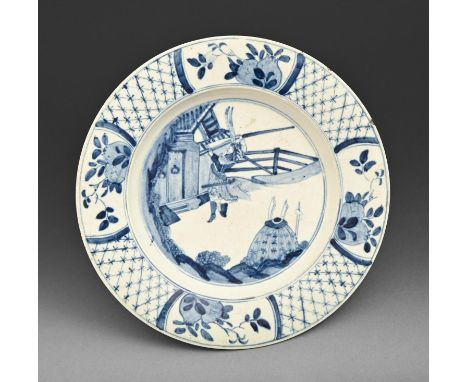 A Bow blue and white plate, c1760, painted after a Chinse Kangxi original with a warrior, the diaper border with four reserve