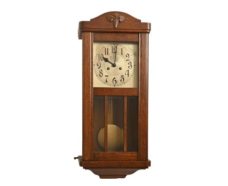 An oak wall clock, 1930s, silvered dial and bevelled glass lights, pendulum, 77cm h and an oak mantel clock (2)  Good conditi