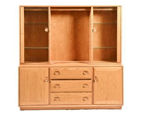 An Ercol ash side cabinet, the upper part with plate glass doors, the lower part fitted with drawers flanked by doors, 160cm 