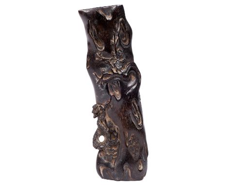 A Chinese carved hardwood wrist rest, 19th / 20th c, the grain of the luxurious dense hardwood resembling rhinoceros horn and