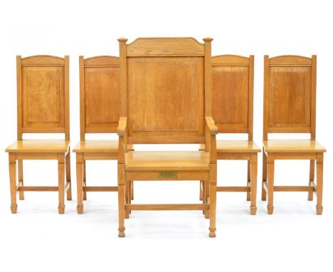 A set of five light oak panel back chairs, mid 20th c, including an armchair with brass memorial tablet, armchair 120cm h  Go