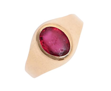 A red stone signet ring, in gold marked 750, 3.1g, size M  Worn, the red stone (or paste) heavily abraded from wear