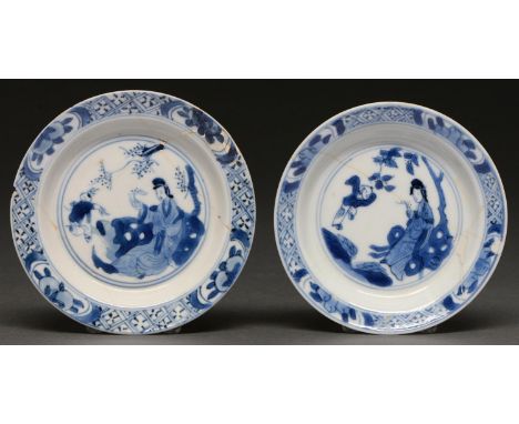 A pair of Chinese miniature blue and white plates or dishes, Kangxi period, painted with the 'Jumping Boy' design in panelled