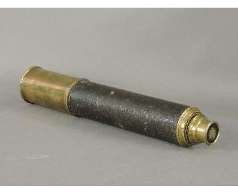 A brass two draw telescope, with a leather sleeve