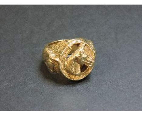 A 9ct gold horseshoe ring, with relief horse heads, 64.5g approximately