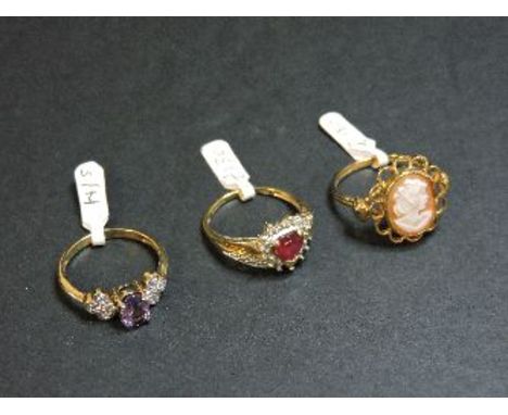 A 9ct gold synthetic ruby and diamond ring, a 9ct gold carved shell cameo ring, and a 9ct gold amethyst and diamond ring