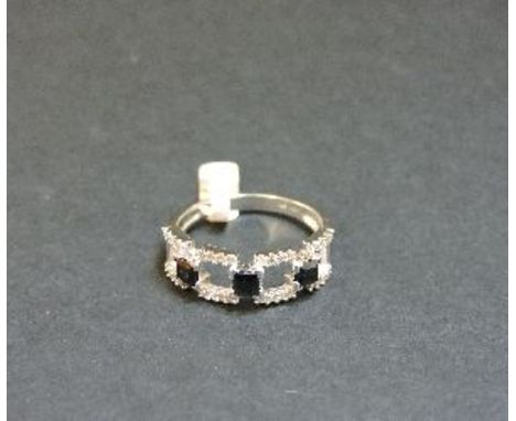 A 9ct white gold sapphire and diamond half hoop ring