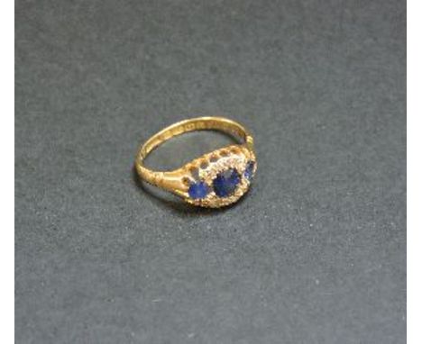 An 18ct gold three stone sapphire and diamond cluster ring, Birmingham 1901