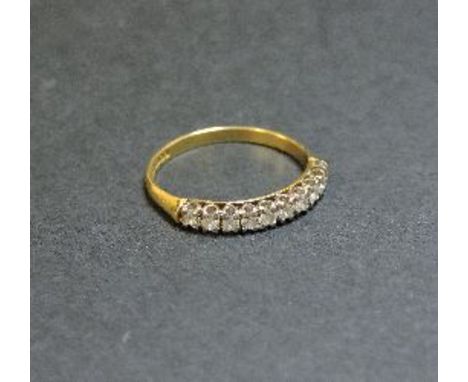 An 18ct gold diamond set half eternity ring