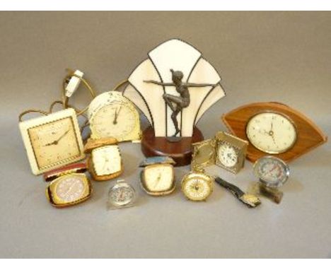 An Art Deco style lamp, a quantity of travelling clocks, a chess clock, and other items