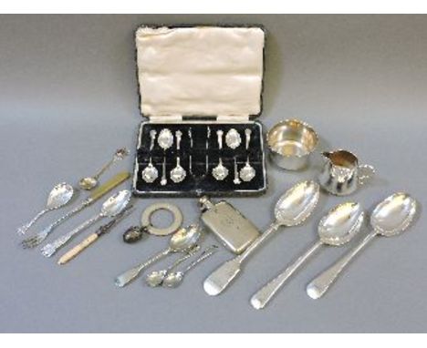 A boxed set of six silver teaspoons and sugar tongs, a silver caddy spoon, a silver teaspoon, together with a silver hip flas