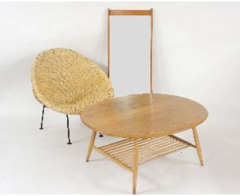 A 'rattan art' woven bamboo basket chair, with iron legs and maker's label, an Ercol coffee table with oval top and spindle u