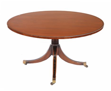 A GEORGIAN STYLE CIRCULAR MAHOGANY BREAKFAST OR DINING TABLE with rosewood cross banded decoration, the base with sabre legs 