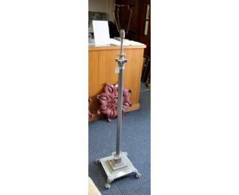 A SILVERED LAMP STANDARD  of Corinthian column form with paw feet, 139cm high (adjustable)