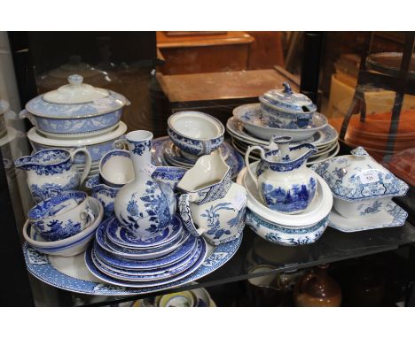 A COLLECTION OF BLUE AND WHITE POTTERY of varying sorts, bowls, serving dishes, cups and saucers, etc.
