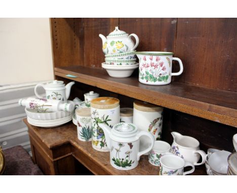 A QUANTITY OF PORTMEIRION FLOWER DECORATED POTTERY to include plates, lidded jars, a teapot, cups and saucers, etc. 