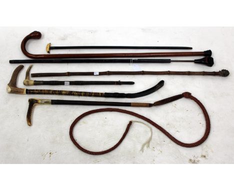 AN ANTIQUE SWORDSTICK, the finial in the form of a clenched fist, together with three various whips and three walking sticks 