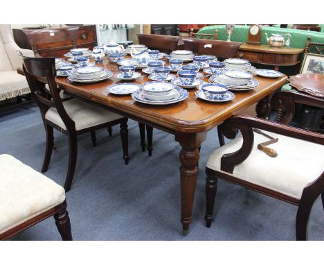 A VICTORIAN MAHOGANY WIND OUT EXTENDING DINING TABLE, rectangular top and standing on turned tapering legs terminating in bra