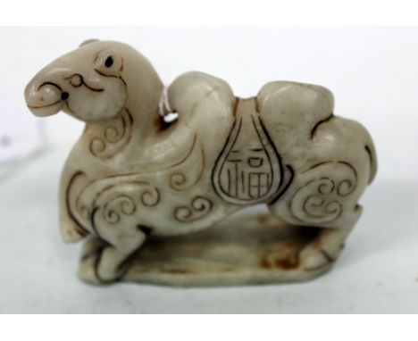 A CARVED ORIENTAL,POSSIBLY JADE, MODEL OF A BACTRIAN CAMEL, 7cm long and 5.5cm high