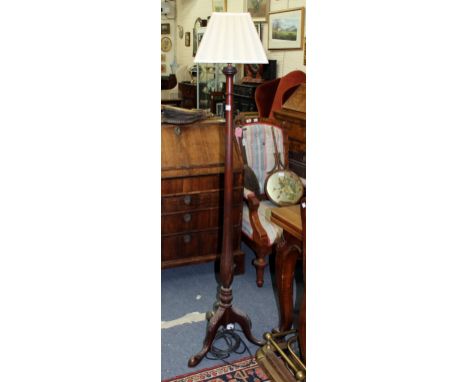 A TURNED MAHOGANY LAMP STANDARD with pleated shade and acanthus leaf carved tripod base