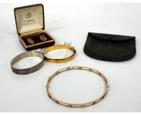 A NINE CARAT GOLD BANGLE, 9.5cm diameter together with a silver bracelet and a pair of oval silver cuff links and a further b