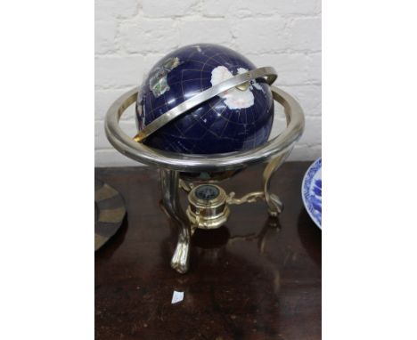 A DECORATIVE GLOBE mounted on a three footed metal base with central compass beneath, 34cm high