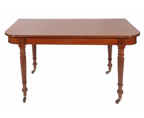 A MAHOGANY TABLE END WITH ROUNDED CORNERS, turned tapering reeded legs and terminating in brass and ceramic castors, 130cm wi