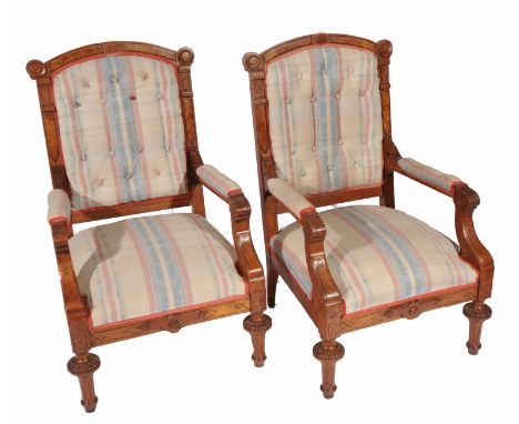 A PAIR OF VICTORIAN OAK AND WALNUT BUTTON UPHOLSTERED OPEN LIBRARY ARMCHAIRS with pad upholstered back and arms, over stuffed